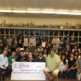 Rick Garvey and Dan Barragan, '80s AHS band alumni, present check for $4435 to current Colonist musicians.