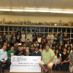 Rick Garvey and Dan Barragan, '80s AHS band alumni, present check for $4435 to current Colonist musicians.